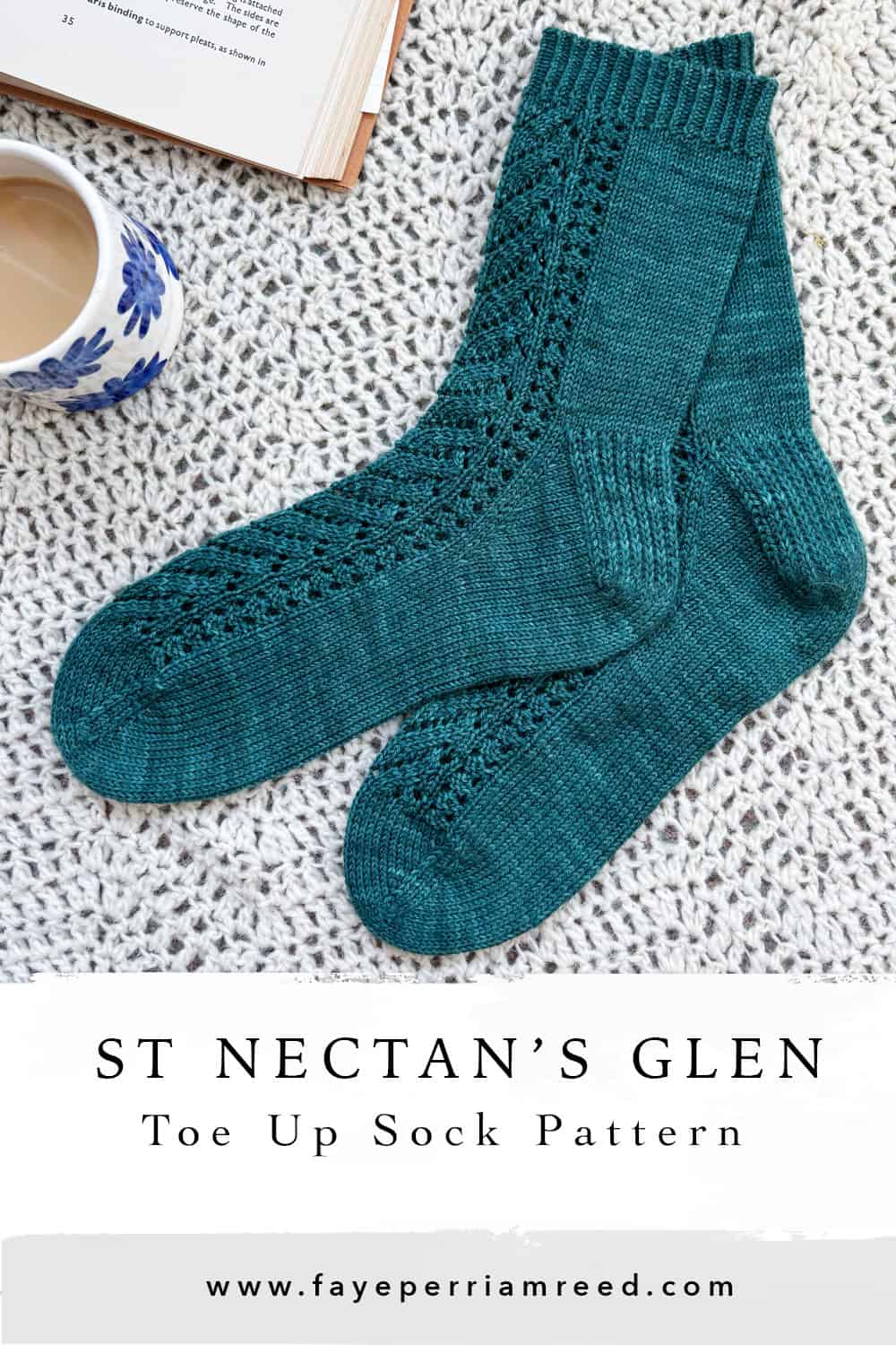 A pair of teal, lace-patterned knitted socks are laid out on a textured cream surface next to a cup of coffee and an open book. Text below reads: ST NECTAN’S GLEN Toe Up Sock Pattern www.fayeperriamreed.com.