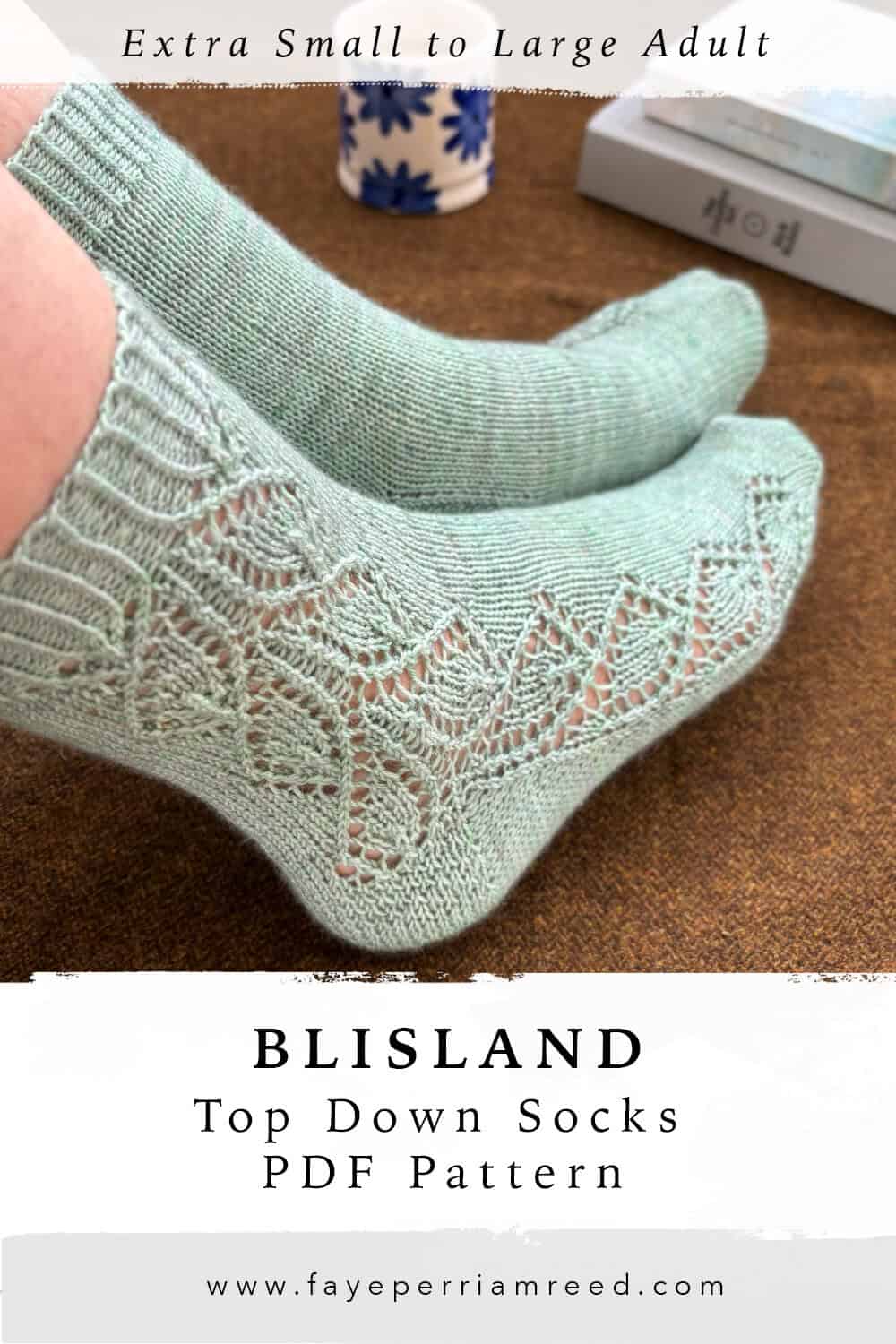 Two feet wearing hand-knit mint green socks, showing the lace side of one sock and the plain side of the other. Text reads BLISLAND Top Down Socks PDF Pattern, Extra Small to Large Adult. Website: www.fayeperriamreed.com.